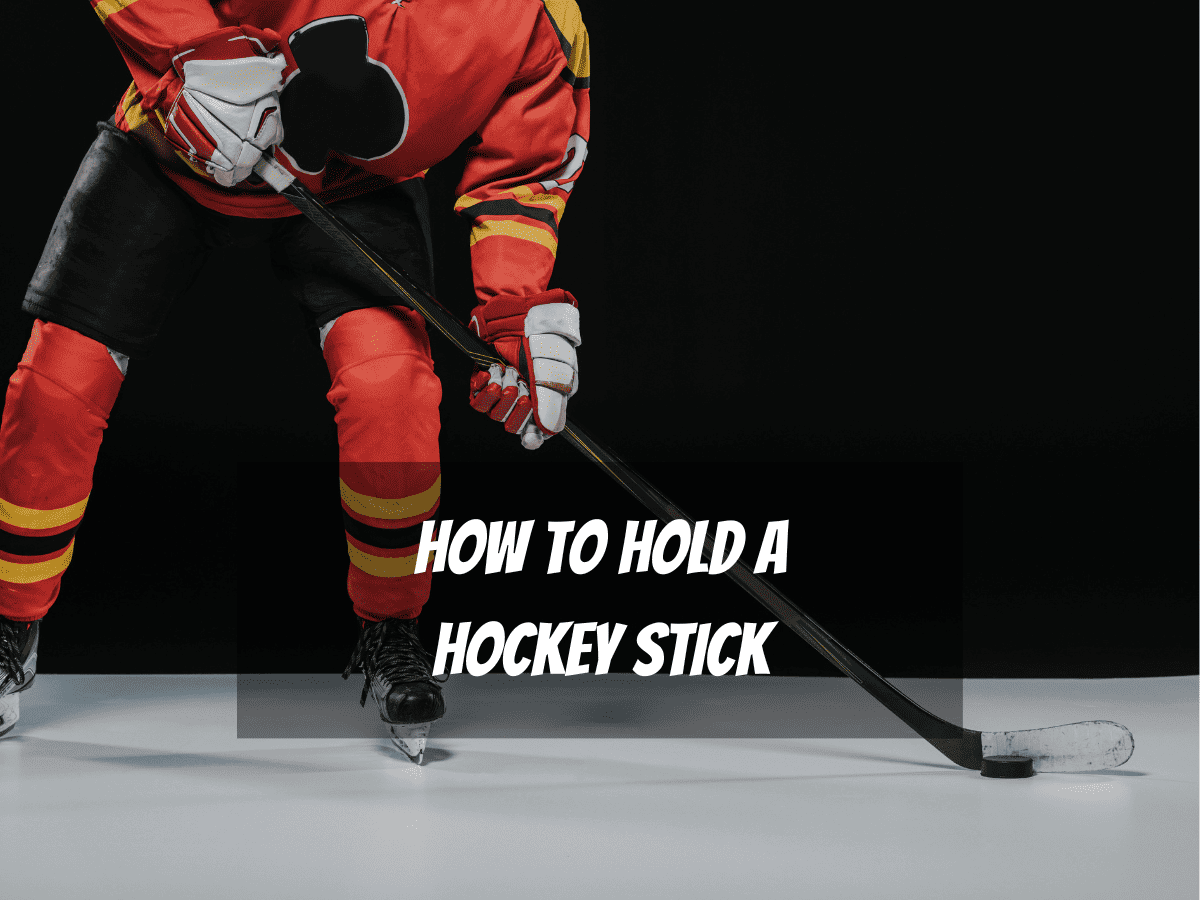 An Ice Hockey Player Wearing A Red Jersey Black Shorts And Red Socks Shows How To Hold A Hockey Skick